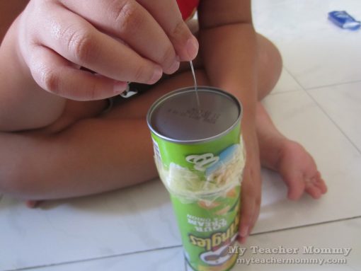 Poke a tiny hole in the center of the metal bottom of the tube. (Pringles can pinhole camera)
